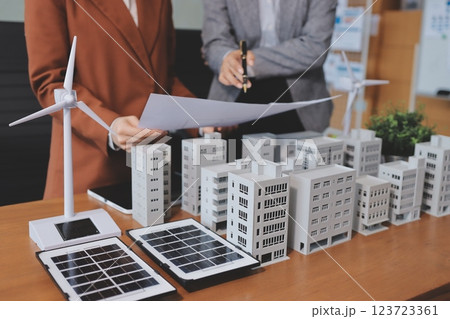 Discussion among businesspeople on the latest developments in solar cell panel technology and Solar Energy Environment city Concept. 123723361