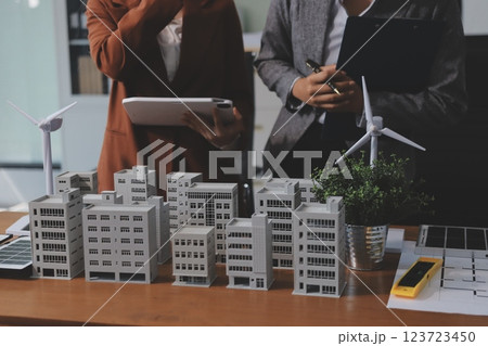 Discussion among businesspeople on the latest developments in solar cell panel technology and Solar Energy Environment city Concept. Discussion among businesspeople on the latest developments in solar cell panel technology and Solar Energy Environment city Concept. 123723450
