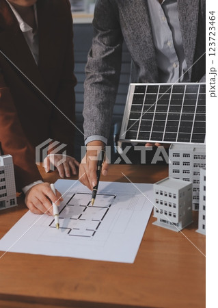 Discussion among businesspeople on the latest developments in solar cell panel technology and Solar Energy Environment city Concept. Discussion among businesspeople on the latest developments in solar cell panel technology and Solar Energy Environment city Concept. 123723464