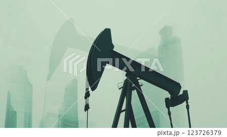 Oil pumpjack stands idle against a background of misty skyscrapers. Concept is industry juxtaposed with urban development. Oil pumpjack stands idle against a background of misty skyscrapers. Concept is industry juxtaposed with urban development. 123726379