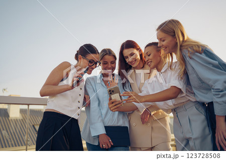 A delightful group of friends enjoying and sharing fun moments together outdoors in nature 123728508