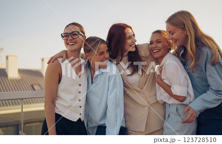 A group of joyful friends celebrating and enjoying each others company outdoors at sunset 123728510