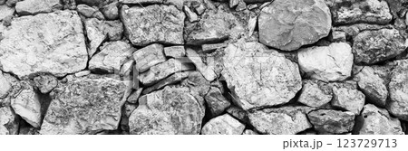 Stone wall texture. Natural stone background in gray tones with selective blur 123729713