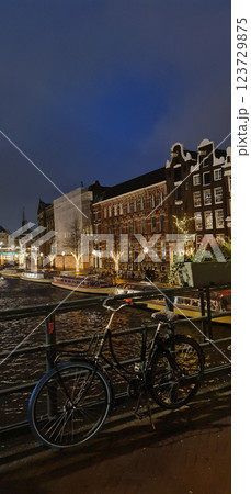 Night Amsterdam city view from bridge with bicycle Night Amsterdam city view from bridge with bicycle 123729875