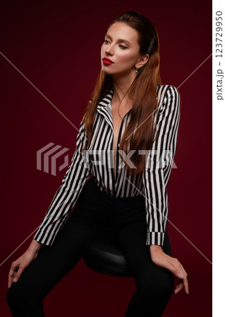 Beauty session of a woman in lingerie striking a pose in a studio setting 123729950