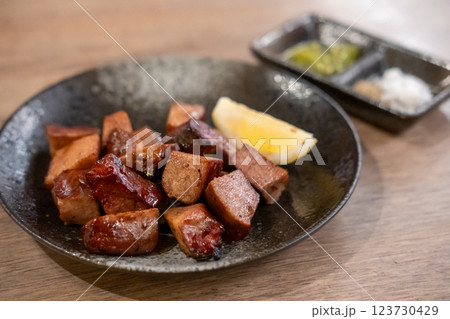 Grilled beef tongue served on plate with lemon Grilled beef tongue served on plate with lemon 123730429