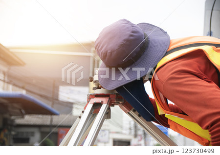 Engineers are using cameras to measure levels. 123730499