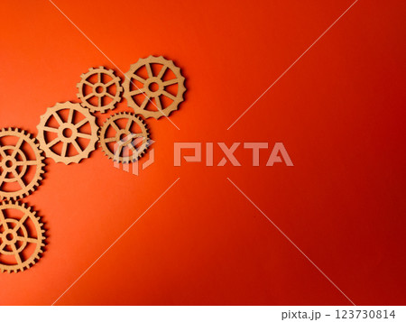 Top view wooden gear on an orange background with copy space. 123730814