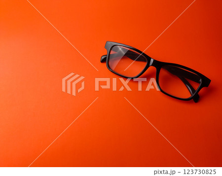 Black glasses on a orange background with copy space. Black glasses on a orange background with copy space. 123730825