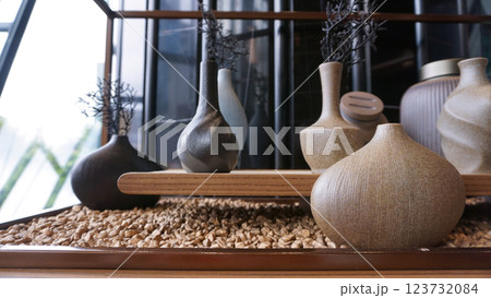 Beige ceramic vases with dry cotton branches. Neutral trendy colors interior decoration . 123732084