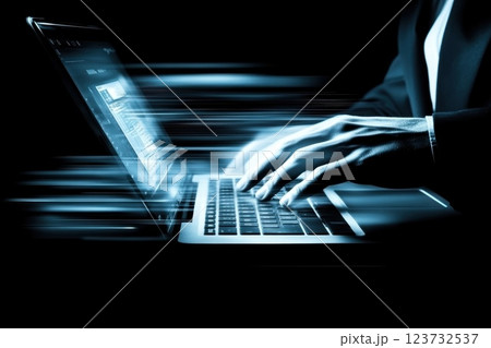 Professional Businessperson Typing on Laptop in Formal Attire against Dark Background 123732537