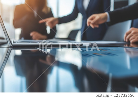 Professionals in Modern Boardroom Discussing Strategies Over a Sleek Conference Table Professionals in Modern Boardroom Discussing Strategies Over a Sleek Conference Table 123732550