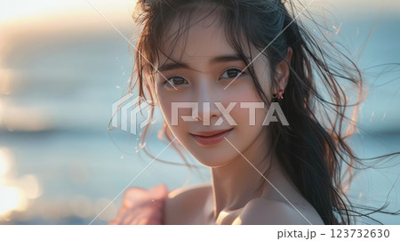 A woman with long hair and a pink dress is smiling at the camera 123732630