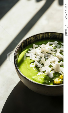 A creamy matcha smoothie bowl topped with a blend of crunchy nuts and sesame seeds, perfect for a nutritious breakfast or snack. The green matcha is complemented by the textured, flavorful toppings A creamy matcha smoothie bowl topped with a blend of crunchy nuts and sesame seeds, perfect for a nutritious breakfast or snack. The green matcha is complemented by the textured, flavorful toppings 123733067