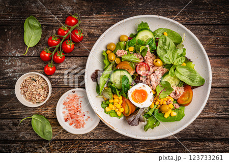 Tuna salad with tomatoes , olives , eggs and onion . Tuna salad with tomatoes , olives , eggs and onion . 123733261