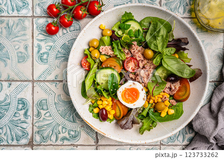 Tuna salad with tomatoes , olives , eggs and onion . Tuna salad with tomatoes , olives , eggs and onion . 123733262