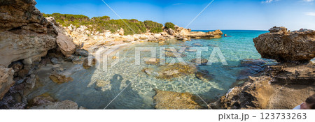 Coastline with a sandy beach and rocky shores near the northeasternmost cape of Northern Cyprus. Crystal-clear waters of a blue lagoon and the untouched beauty of the Mediterranean 123733263