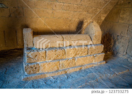 Ancient sarcophagus inside the historic fortress of Kyrenia or Girne in Northern Cyprus. Carved stone details and the dimly lit interior emphasize the mystery and historical depth of the site 123733275