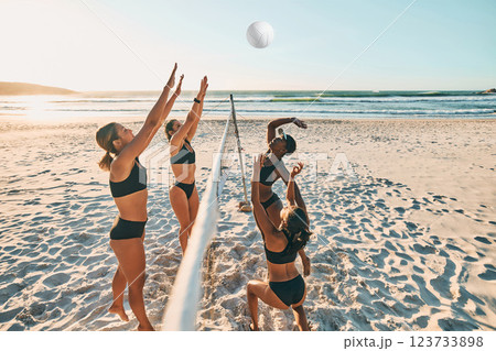 Volleyball, team sports and women on the beach during group holiday together in Miami in summer. Happy, excited and young friends playing sport game in bikini by the sea on vacation with energy 123733898