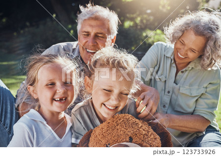 Family, children and love with a girl, grandparents and sister outdoor in a nature park for fun and adventure. Kids, park and picnic with an elderly male, female and grandchildren laughing outside 123733926