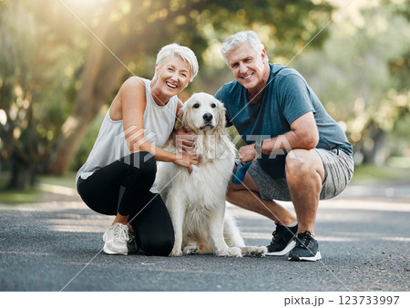 Happy senior couple, walking dog in nature park and smile bonding with their golden retriever together. Healthy living in retirement, being physically active by exercising and relaxing time with pet 123733997