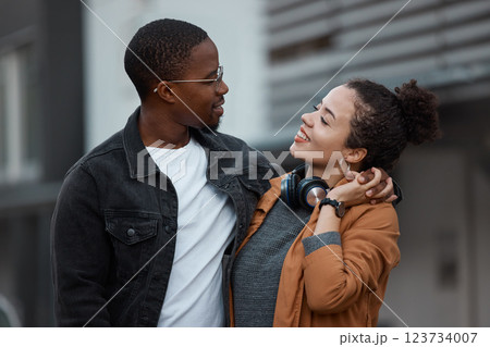 Young couple walking in the city on the street, holding hands and in love. Dating, love and black woman with black man in multicultural relationship, smiling and hugging taking walk in urban town Young couple walking in the city on the street, holding hands and in love. Dating, love and black woman with black man in multicultural relationship, smiling and hugging taking walk in urban town 123734007