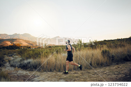 Man running in nature, marathon fitness training exercise and healthy sunrise cardio workout. Sports runner, racing on hiking path and working out for athletic speed or energy in race competition 123734022