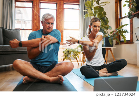 Couple, stretching and yoga with laptop to watch online video tutorial. Senior man and woman warm up with pilates and exercise on virtual class on the floor with peace, fitness and training 123734024