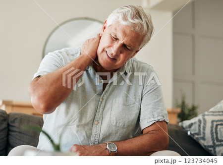 Senior man, neck pain and stress sitting at home with spine injury massaging muscle for osteoporosis and fibromyalgia. Bad health, tired and elderly male with orthopedic, arthritis and back problem 123734045