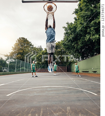 Basketball, player and winner on court jump, makes basket and score, celebration and victory playing against team. Competition, game day and dunk ball in net excited, practice and winning the game. 123734071