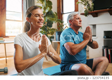 Meditation, wellness and yoga by elderly couple exercise and relax on a floor, bonding in a living room together. Zen, peace and fitness workout by mature man and woman exercising and doing cardio 123734135