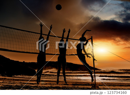 Sports, beach and volleyball at sunset by women silhouette jumping for ball together, fun, travel and summer. Energy, fitness and exercise with sports friends playing beach volleyball game in Brazil Sports, beach and volleyball at sunset by women silhouette jumping for ball together, fun, travel and summer. Energy, fitness and exercise with sports friends playing beach volleyball game in Brazil 123734160