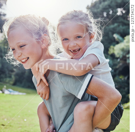 Happy, smile and siblings in an outdoor park during summer having fun and playing in nature. Happiness, excited and girl children on an adventure giving a piggy back ride outside in a green garden. 123734172