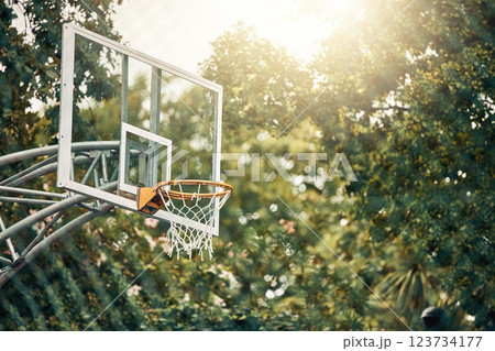 Nature, basketball court and basket for fitness training and game tournament score exercise. Outdoor sports venue net for competition goal practice and cardio workout with sunshine flare. Nature, basketball court and basket for fitness training and game tournament score exercise. Outdoor sports venue net for competition goal practice and cardio workout with sunshine flare. 123734177