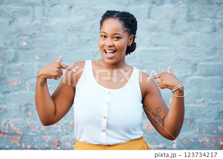 Black woman, pointing and happy feeling proud and self assured choosing herself against city building wall, mockup space or outside in Nigeria. Portrait of African model with a fun or playful gesture Black woman, pointing and happy feeling proud and self assured choosing herself against city building wall, mockup space or outside in Nigeria. Portrait of African model with a fun or playful gesture 123734217