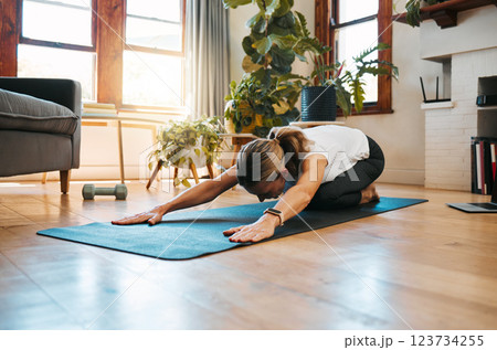 Exercise, fitness and yoga stretching for health, wellness and healthy body, mind and spirit on living room floor. Calm woman start with pilates, workout and training with balance and meditation Exercise, fitness and yoga stretching for health, wellness and healthy body, mind and spirit on living room floor. Calm woman start with pilates, workout and training with balance and meditation 123734255