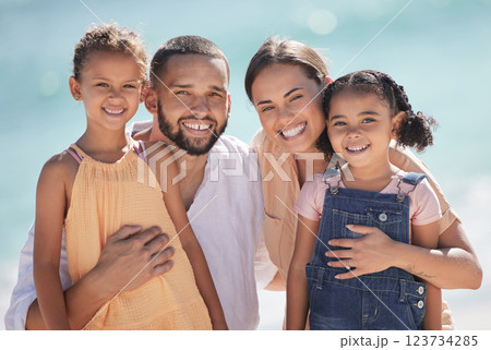 Family, happy at the beach and smile out in the sun while they enjoy and love to spend quality time together. Dad and mom hug kids, they bond and have fun on summer vacation in portrait. Family, happy at the beach and smile out in the sun while they enjoy and love to spend quality time together. Dad and mom hug kids, they bond and have fun on summer vacation in portrait. 123734285