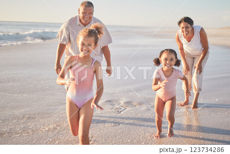 Beach, girl children and grandparents running on sand ocean in summer for healthy body, outdoor wellness and growth development. Happy family with love, support and care for kids having fun in sea 123734286