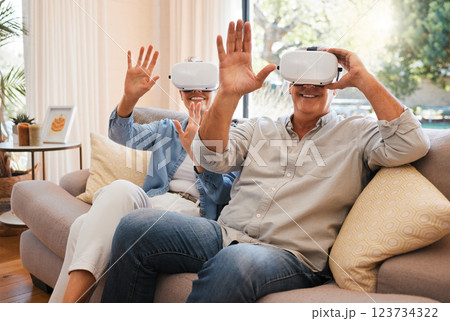 Gaming, vr and senior couple on a sofa, virtual reality and fun in a living room. Metaverse, fantasy and retirement by elderly man and woman enjoying playful, creative and virtual game in their home Gaming, vr and senior couple on a sofa, virtual reality and fun in a living room. Metaverse, fantasy and retirement by elderly man and woman enjoying playful, creative and virtual game in their home 123734322