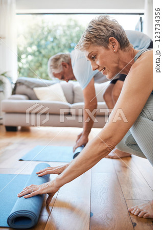 Senior couple, rolling yoga mat and home workout, fitness and exercise on living room floor. Elderly people on lounge ground for pilates training, healthy lifestyle and balance body wellness together 123734356