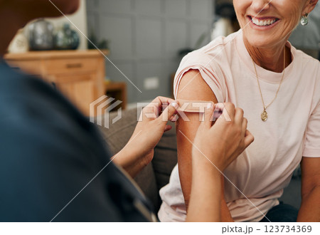 Woman, smile and plaster after injection for vaccine against covid. Happy, senior and lady vaccination for coronavirus on sofa in doctor office for health, wellness and safety from global pandemic Woman, smile and plaster after injection for vaccine against covid. Happy, senior and lady vaccination for coronavirus on sofa in doctor office for health, wellness and safety from global pandemic 123734369