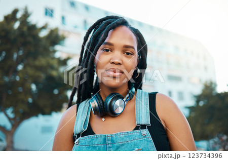 City, urban and headphones black woman portrait in urban gen z fashion, outdoor travel or youth lifestyle. Young, trendy african girl or student face with technology for 5g audio streaming in summer City, urban and headphones black woman portrait in urban gen z fashion, outdoor travel or youth lifestyle. Young, trendy african girl or student face with technology for 5g audio streaming in summer 123734396