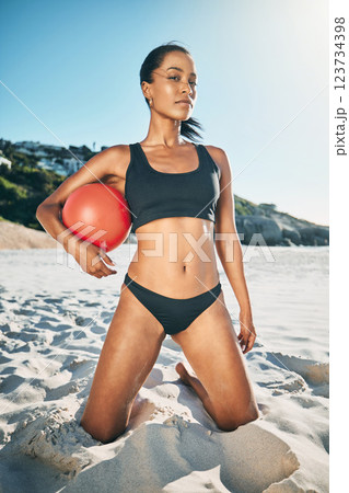 Volleyball, ball and fit woman on beach vacation while enjoying summer sports, fitness and training in brazil. Strong, young and girl athlete in sand with a bikini body and fun ready to play a game 123734398
