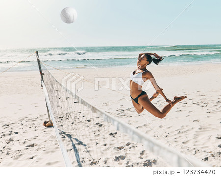 Black woman, beach and volleyball for fitness, health and exercise on vacation in summer. Girl, sports or ocean play with ball on sand to workout for wellness in sunshine on holiday in Cancun, Mexico 123734420