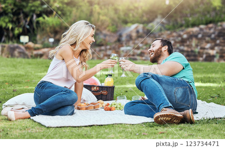 Couple, picnic and park of a man and woman cheers to happiness and love in nature. Happy people together with a smile enjoying alcohol and food laughing with quality time for an anniversary outdoor 123734471