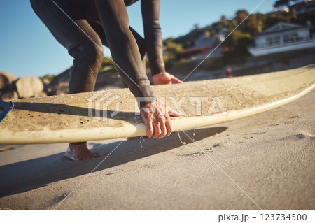 Hands, surfboard and beach surfer man on holiday, vacation or summer trip in Hawaii. Fitness, workout and male pick up board ready for surfing sports, fitness or exercise by sandy seashore outdoors. Hands, surfboard and beach surfer man on holiday, vacation or summer trip in Hawaii. Fitness, workout and male pick up board ready for surfing sports, fitness or exercise by sandy seashore outdoors. 123734500
