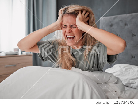 In bed in the morning with stress, angry and agro woman. Depressed girl in bedroom, hands on head and screaming in pain. Overworked, frustrated and wake up with headache from insomnia 123734506
