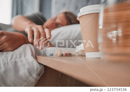 Depression pills, insomnia medicine and woman sleeping in bed for pharmaceutical, psychology or mental health awareness. Depressed, addiction and sick or sad person and drugs help or risk in bedroom 123734536