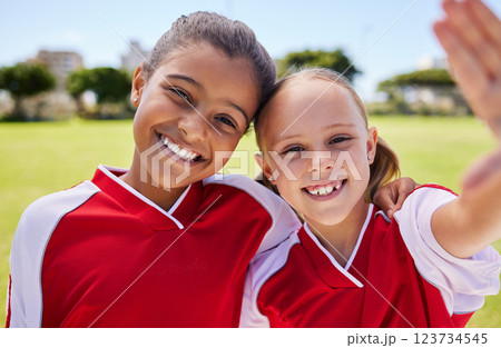 Selfie, soccer and sport with a girl team taking a photograph on a football field before a game with a smile. Children, sports and exercise with female child friends posing for a picture outside Selfie, soccer and sport with a girl team taking a photograph on a football field before a game with a smile. Children, sports and exercise with female child friends posing for a picture outside 123734545