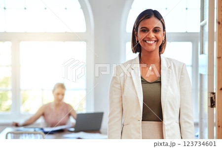 Vision, mission and mindset with a business woman or designer standing in her office with a smile on her face. Creative, design and success with a female employee working towards a future goal 123734601